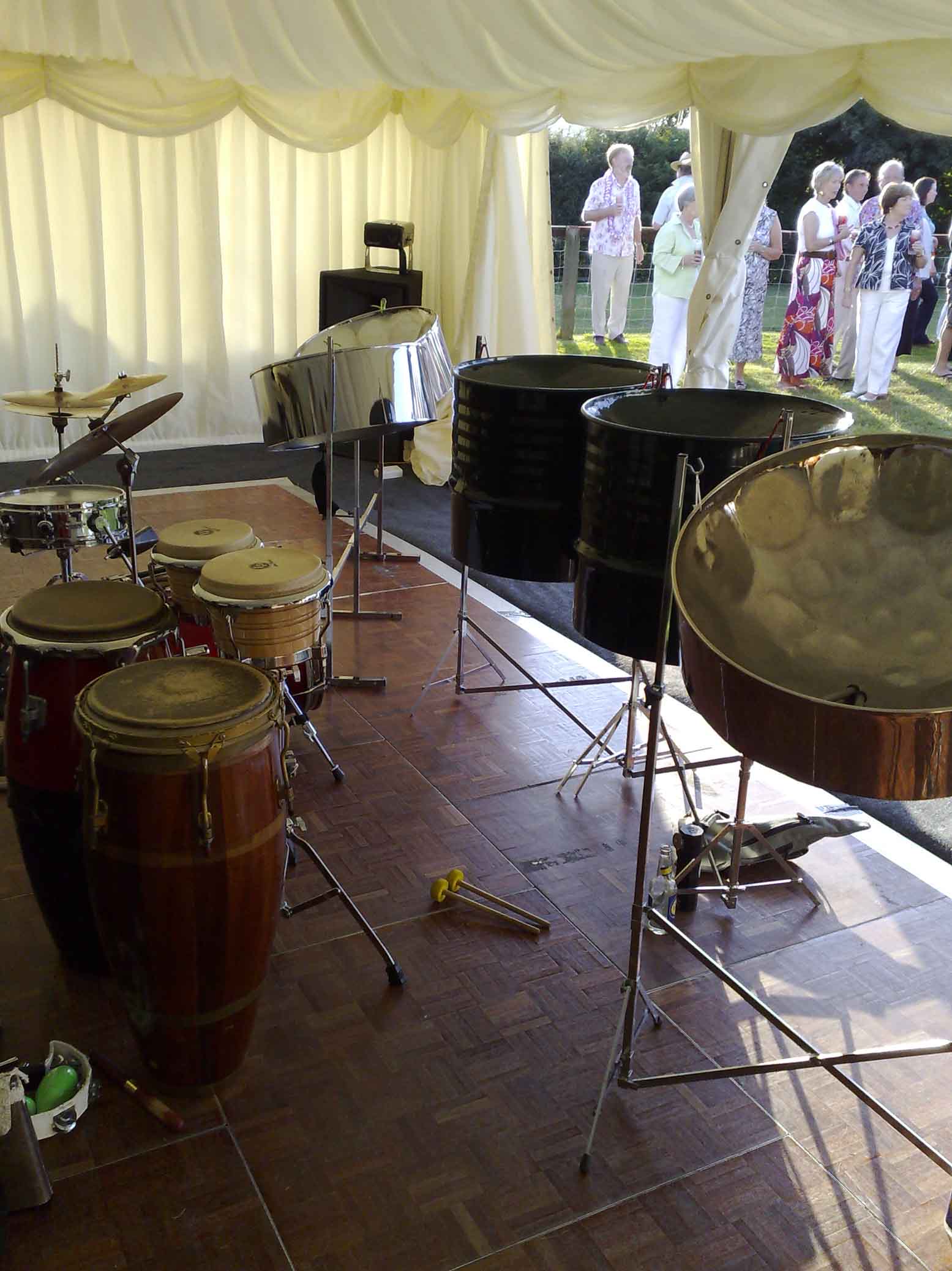 Five-piece steel drum band performing at a 50th birthday party in London, available for hire in London, Cambridge, Essex, Hertfordshire, and surrounding areas.