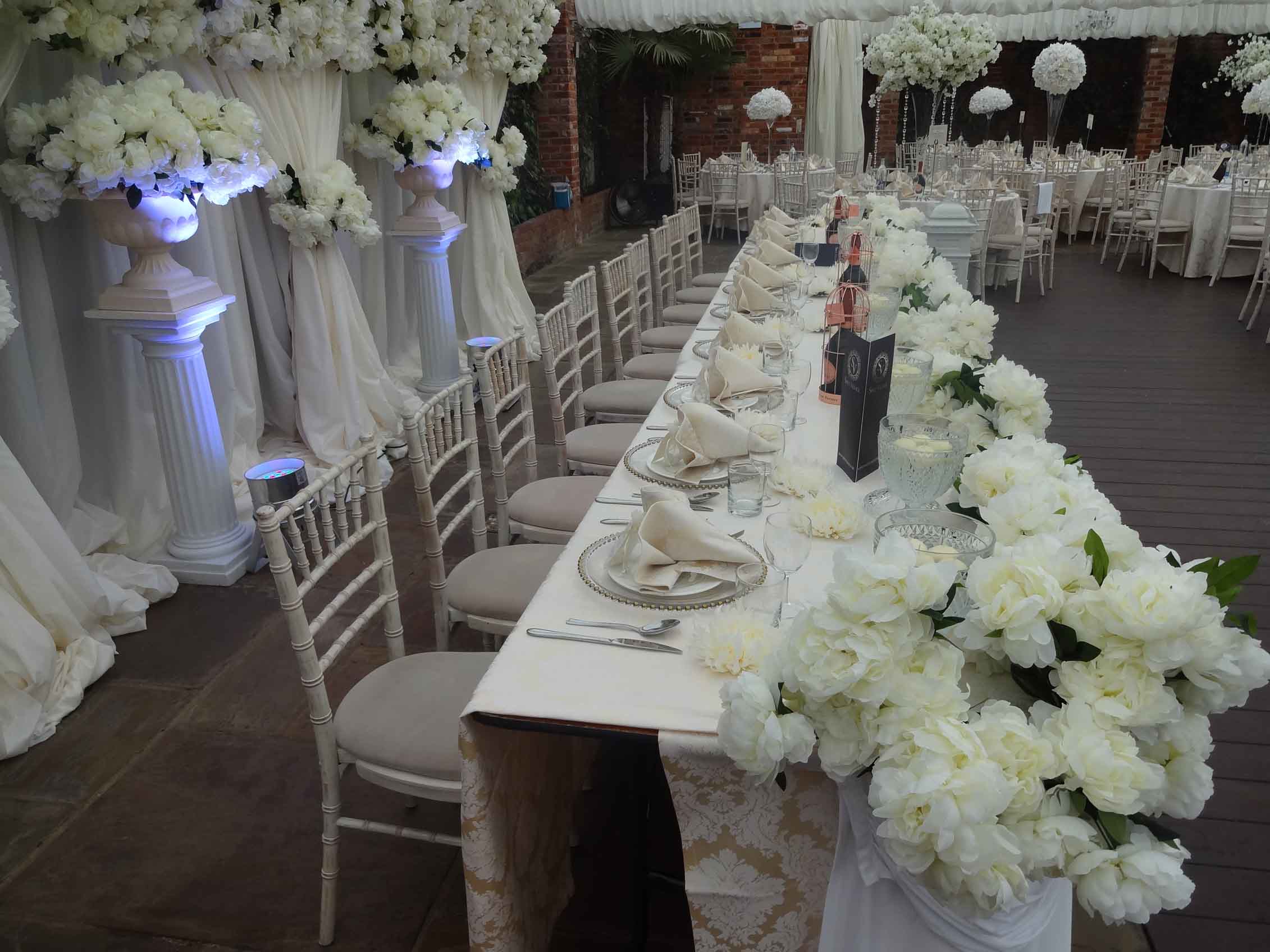 Luxury wedding decor at a reception in London, featuring lavish floral arrangements and steel pan band music, ideal for stylish wedding ideas.